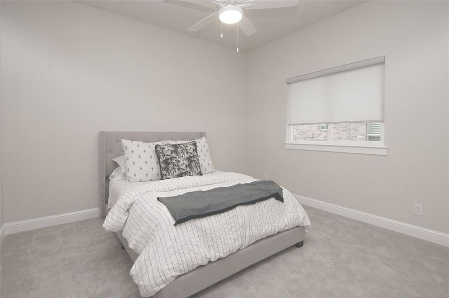 Carpeted bedroom with baseboards and ceiling fan