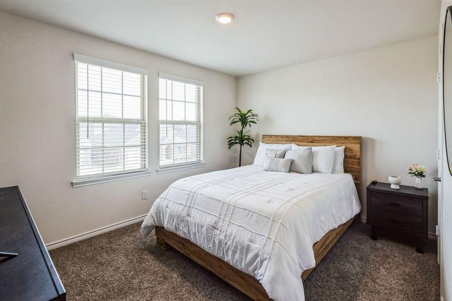 Bedroom featuring dark carpet