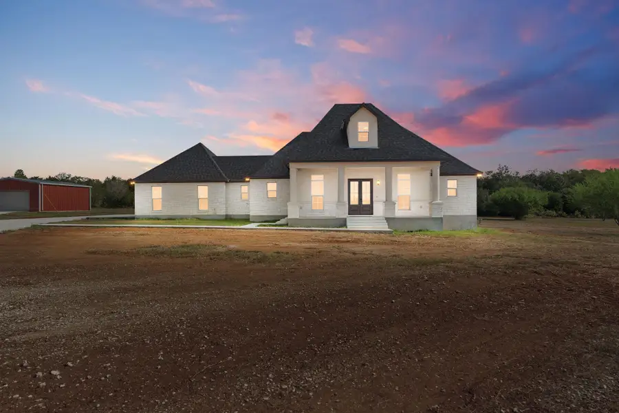 Modern inspired farmhouse featuring covered porch and a shingled roof Modern inspired farmhouse featuring covered porch and a shingled roof