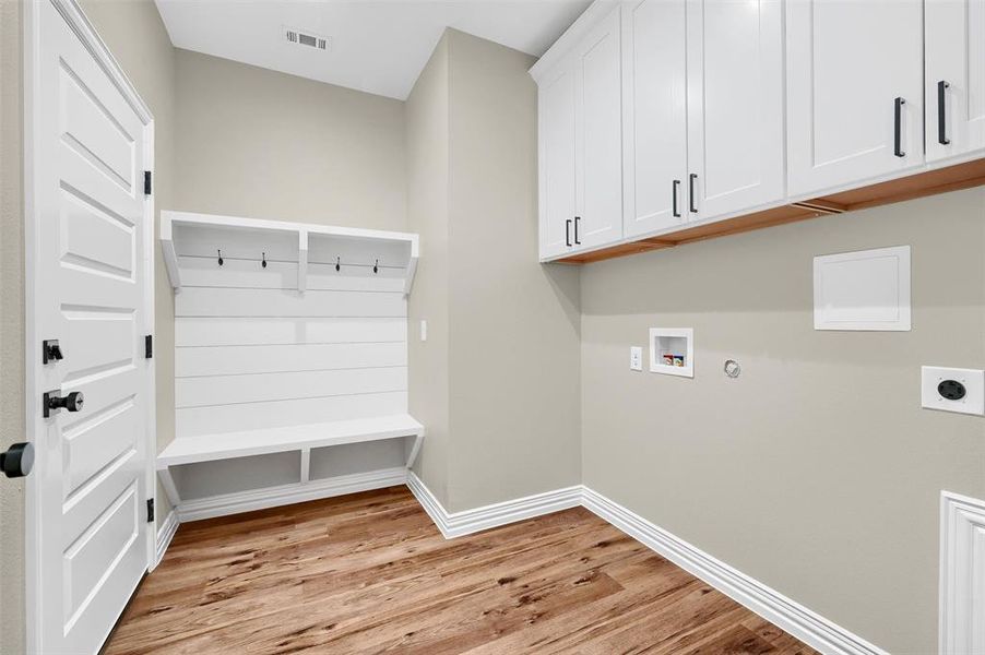 Mudroom with light hardwood / wood-style floors