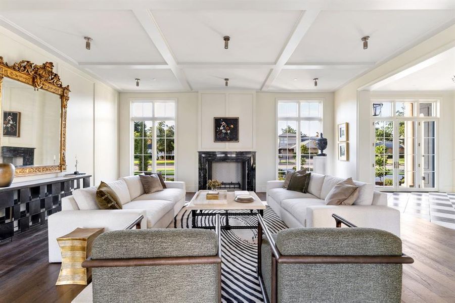 Living area featuring a fireplace, wood finished floors, coffered ceiling, and beam ceiling Living area featuring a fireplace, wood finished floors, coffered ceiling, and beam ceiling