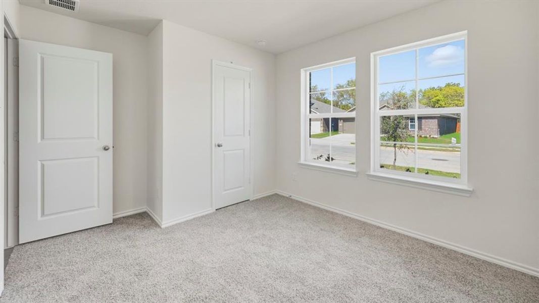 Unfurnished bedroom featuring baseboards and light colored carpet Unfurnished bedroom featuring baseboards and light colored carpet