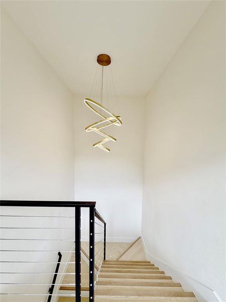 Staircase featuring wood finished floors and baseboards