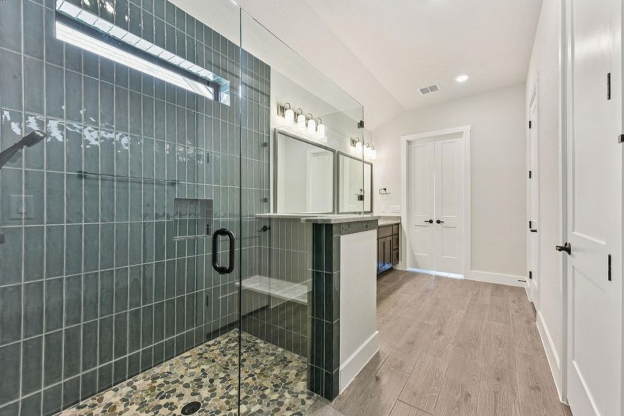 Bathroom featuring light wood finished floors, vanity, a shower stall, and recessed lighting Bathroom featuring light wood finished floors, vanity, a shower stall, and recessed lighting