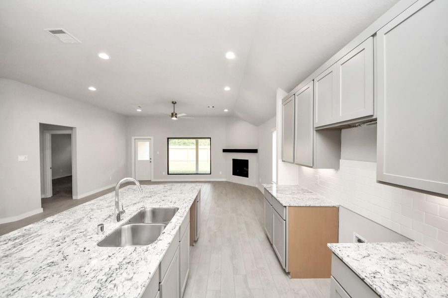 The open concept effortlessly connects the kitchen to the expansive family room, forming a perfect hub for gatherings. This seamless flow creates an inviting space where cooking and socializing come together harmoniously. Sample photo of completed home with similar floor plan. Actual colors and selections may vary. The open concept effortlessly connects the kitchen to the expansive family room, forming a perfect hub for gatherings. This seamless flow creates an inviting space where cooking and socializing come together harmoniously. Sample photo of completed home with similar floor plan. Actual colors and selections may vary.