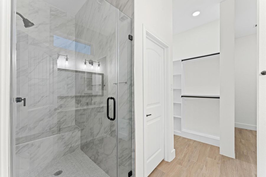 Spa-like primary bath featuring dual sinks, a luxurious walk-in shower with designer tile, and modern finishes that create a serene retreat for relaxation. Spa-like primary bath featuring dual sinks, a luxurious walk-in shower with designer tile, and modern finishes that create a serene retreat for relaxation.
