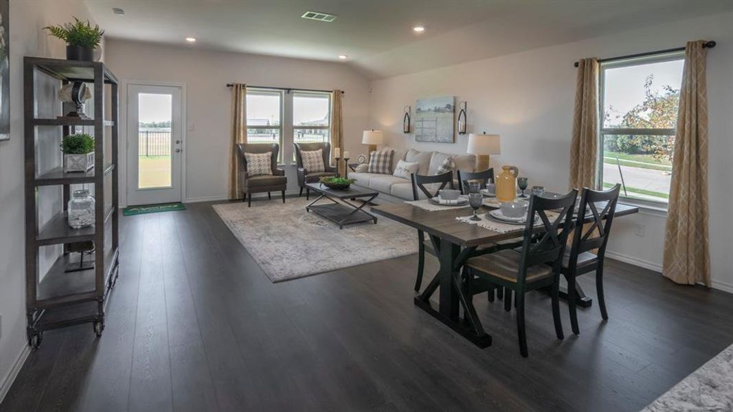 Dining area featuring dark wood-type flooring and recessed lighting