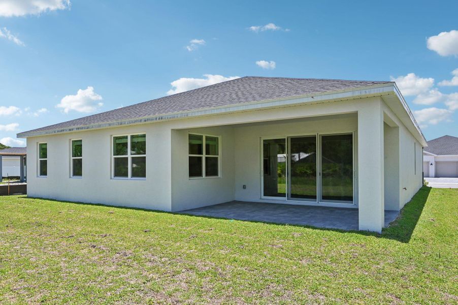Front exterior of a new home in Hampton Park - Signature Series, Vero Beach, FL, highlighting curb appeal (Image 1).