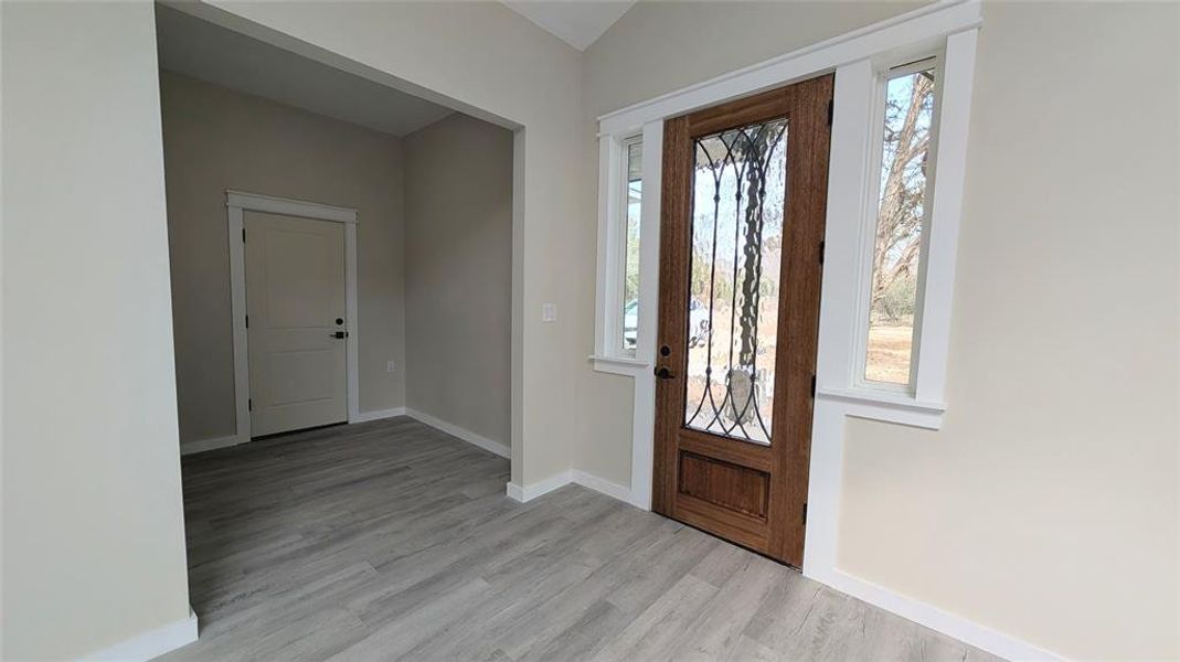 entry with 1/2 bath and garage entrance to right entry with 1/2 bath and garage entrance to right