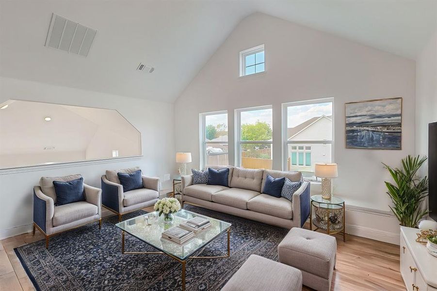 Virtually Staged view of the upstairs living area, overlooking the floor below to showcase potential as full living room.