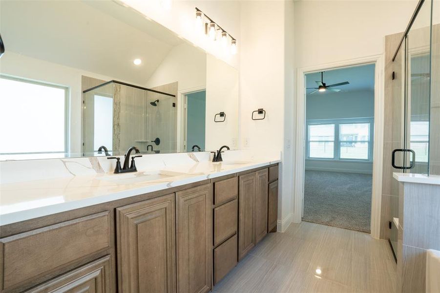 Double vanity boasts beautiful quartz countertops. Double vanity boasts beautiful quartz countertops.