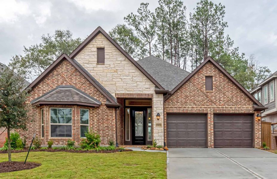 Representative exterior photo of a completed home built from the 2349 by Ravenna Homes in The Highlands 55′, Porter, TX (Image 1). Representative exterior photo of a completed home built from the 2349 by Ravenna Homes in The Highlands 55′, Porter, TX (Image 1).