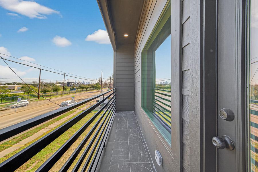 Private balcony off of front bedroom offering outdoor living space with view of Downtown.