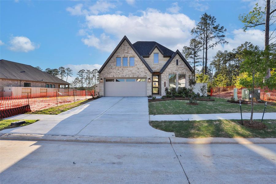Front exterior of a new home in Audubon, Magnolia, TX, highlighting curb appeal (Image 1). Front exterior of a new home in Audubon, Magnolia, TX, highlighting curb appeal (Image 1).