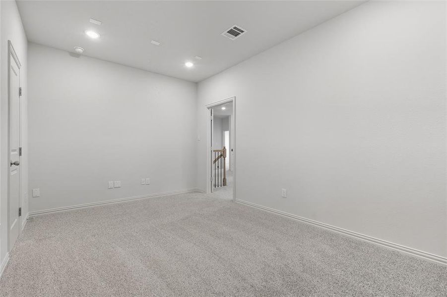 Empty room featuring light colored carpet and recessed lighting Empty room featuring light colored carpet and recessed lighting