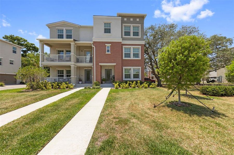 Front exterior of a new home in Townes at Manhattan Crossing, Tampa, FL, highlighting curb appeal (Image 28).