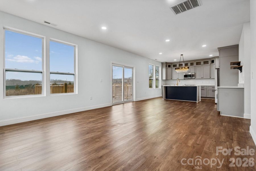 main living room offers open concept, recessed lighting, abundance of natural light and access to the rear deck