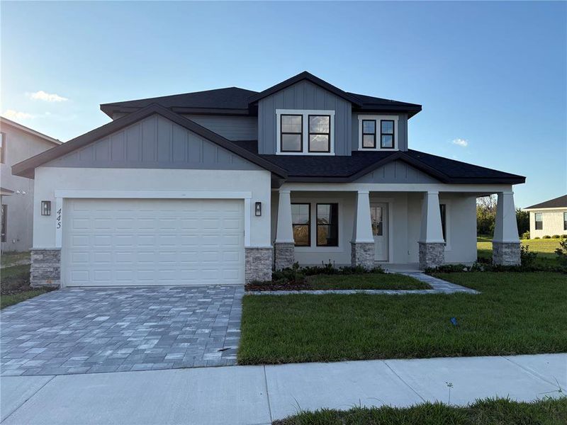 Front exterior of a new home in , Auburndale, FL, highlighting curb appeal (Image 1).