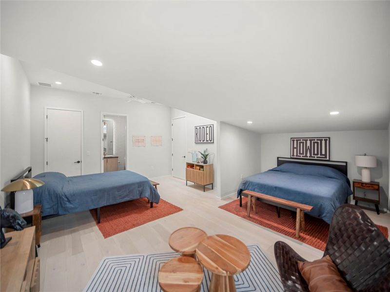 Bedroom with recessed lighting, light wood-type flooring, and connected bathroom