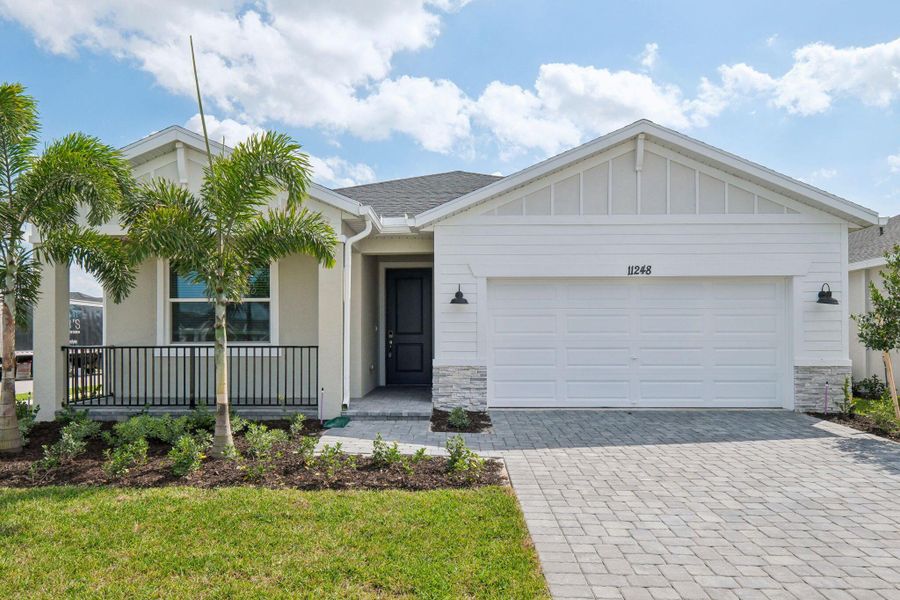 Front exterior of a new home in Brystol at Wylder - Reserve Series, Port St. Lucie, FL, highlighting curb appeal (Image 1). Front exterior of a new home in Brystol at Wylder - Reserve Series, Port St. Lucie, FL, highlighting curb appeal (Image 1).