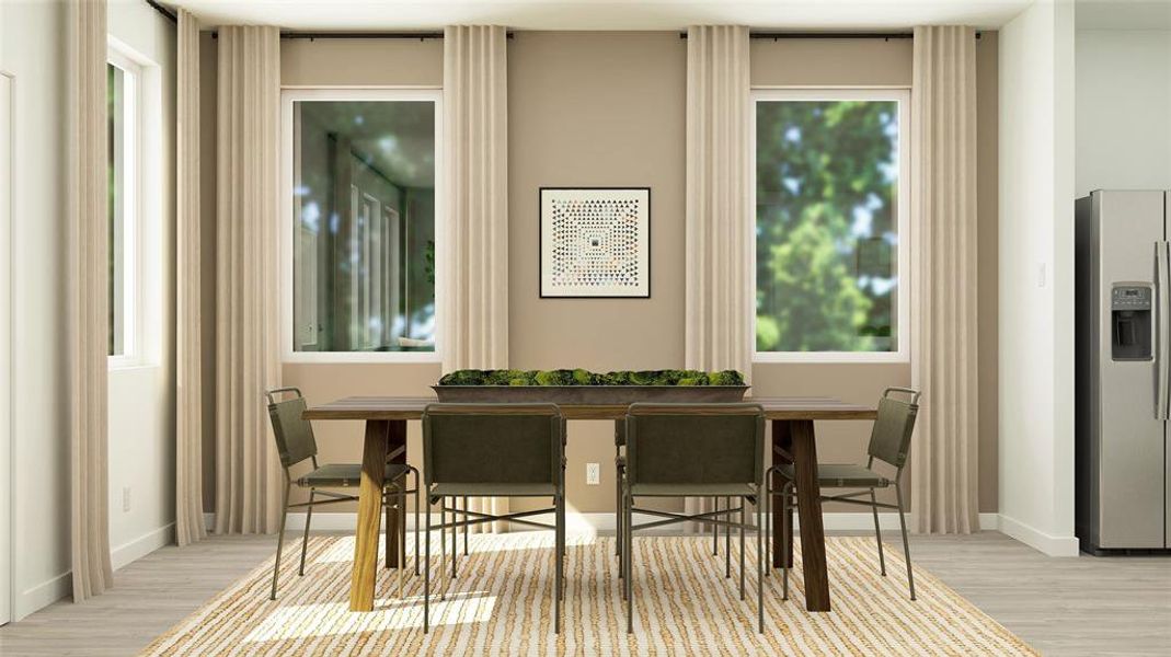 Dining room featuring baseboards, breakfast area, and light wood-style floors