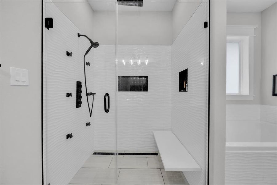 Bathroom with tile patterned floors and separate shower and tub