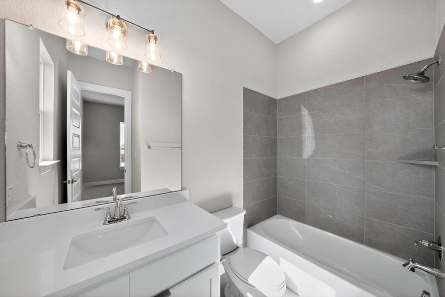 Full bathroom with bathing tub / shower combination and vanity Full bathroom with bathing tub / shower combination and vanity