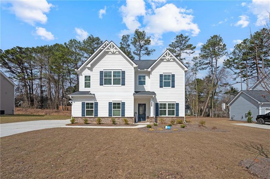 Front exterior of a new home in Stephen's Landing, Loganville, GA, highlighting curb appeal (Image 33). Front exterior of a new home in Stephen's Landing, Loganville, GA, highlighting curb appeal (Image 33).