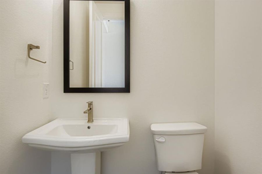 Half bath with toilet and a sink Half bath with toilet and a sink