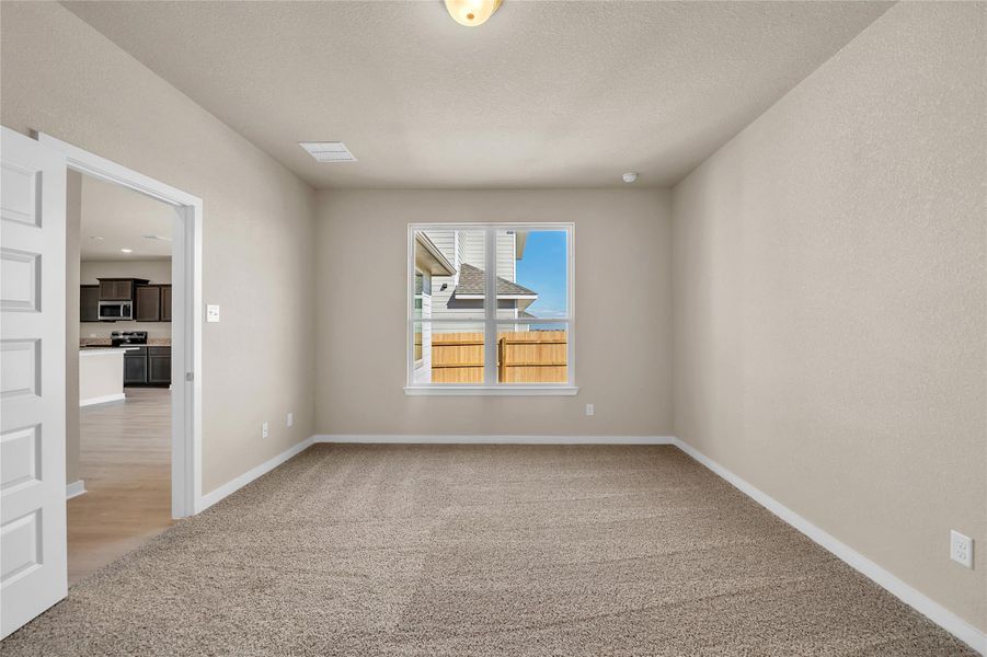 Spare room with light carpet and a textured ceiling
