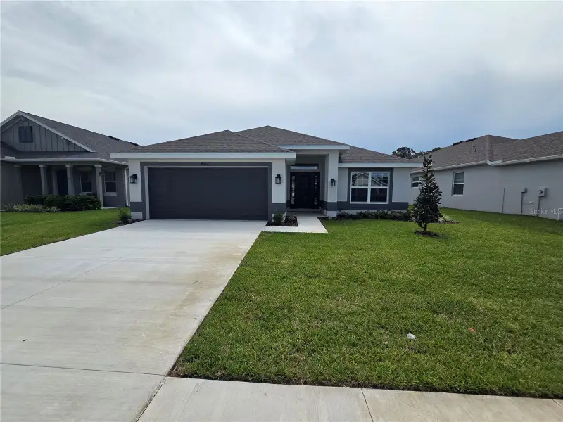 Front exterior of a new home in Highland Hills, Hudson, FL, highlighting curb appeal (Image 1). Front exterior of a new home in Highland Hills, Hudson, FL, highlighting curb appeal (Image 1).