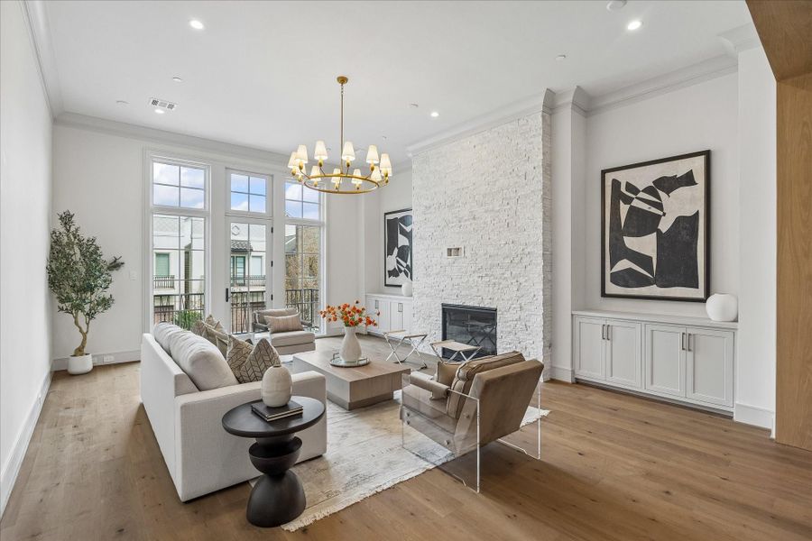 The fireplace features an IntelliFire Touch Ignition System––user-friendly ambience! The floor-to-ceiling white stack stone fireplace features recessed electrical plug and cable conduit leading to the side cabinet for television mounting.