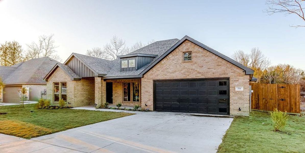 View of front facade with a front yard and a garage