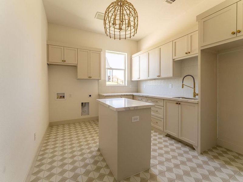 Washroom featuring electric dryer hookup, light flooring, washer hookup, and cabinet space