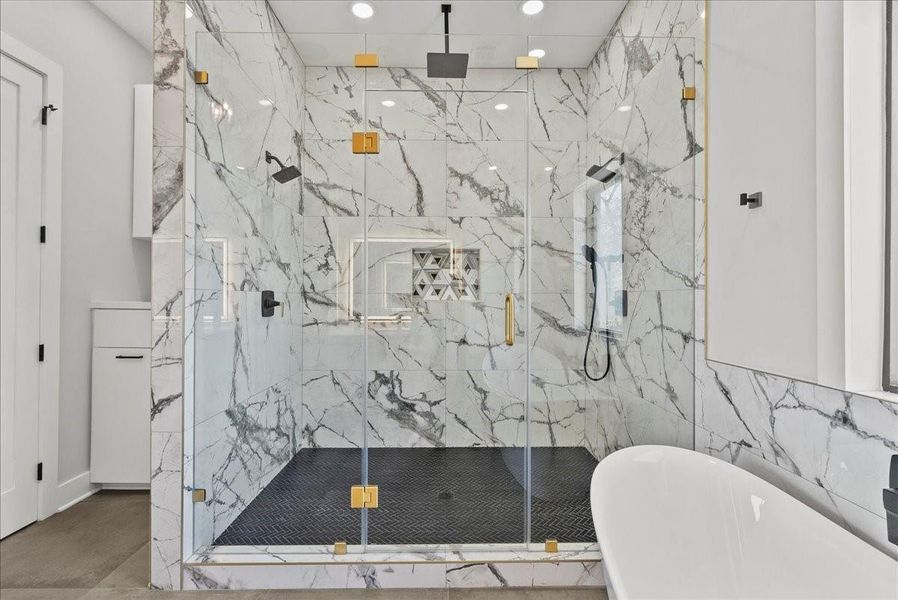 The oversized walk-in shower features multiple showerheads, including a soothing rain shower, with porcelain tile carried all the way to the ceiling — pure spa-level luxury. The oversized walk-in shower features multiple showerheads, including a soothing rain shower, with porcelain tile carried all the way to the ceiling — pure spa-level luxury.