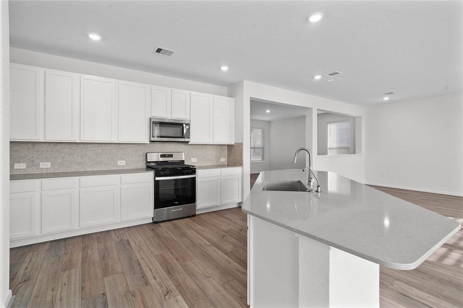 This kitchen is by far any chef’s dream! This spacious kitchen features high ceilings, white stained wood cabinets, silestone countertops, SS appliances, modern tile backsplash, recessed lighting, extended counter space, silestone kitchen island with sink, space for breakfast bar and a pantry all overlooking your huge family room.