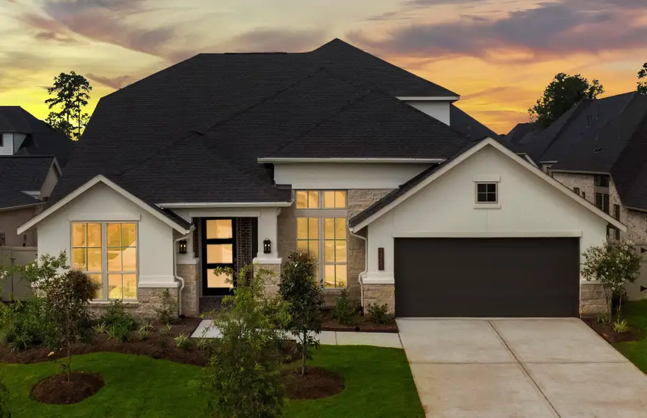 Front exterior of a new home in Audubon 60', Magnolia, TX, highlighting curb appeal (Image 2).