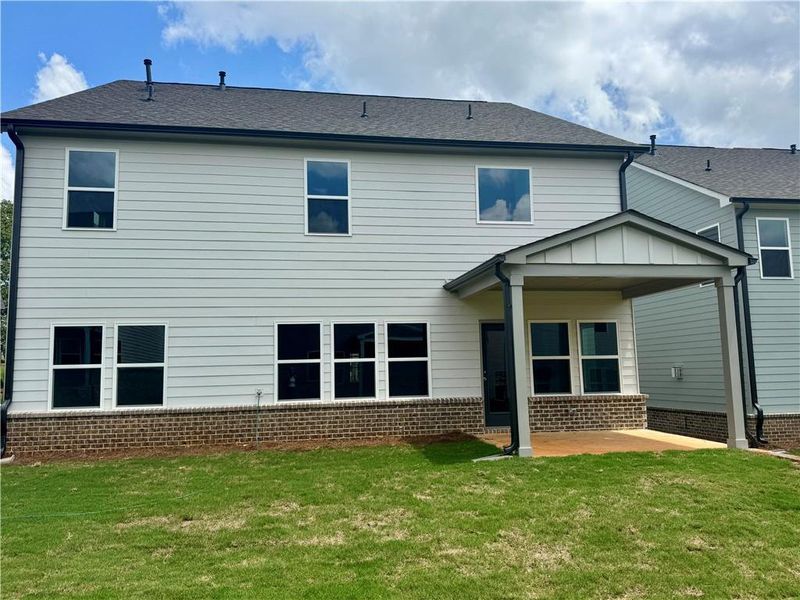 Front exterior of a new home in Eastlyn Crossing - Single Family, Flowery Branch, GA, highlighting curb appeal (Image 21). Front exterior of a new home in Eastlyn Crossing - Single Family, Flowery Branch, GA, highlighting curb appeal (Image 21).