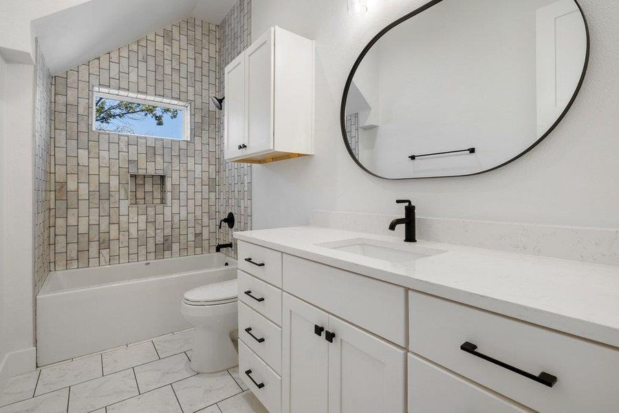 Bathroom featuring vanity and washtub / shower combination