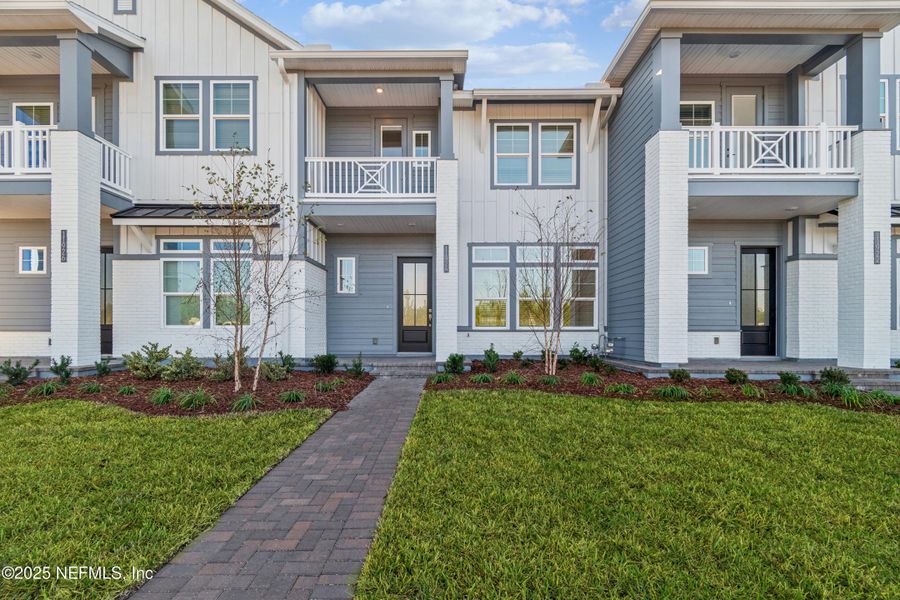 Exterior details and patio area of a home in Seven Pines 24' Rear Entry Townhomes, Jacksonville (Image 21).