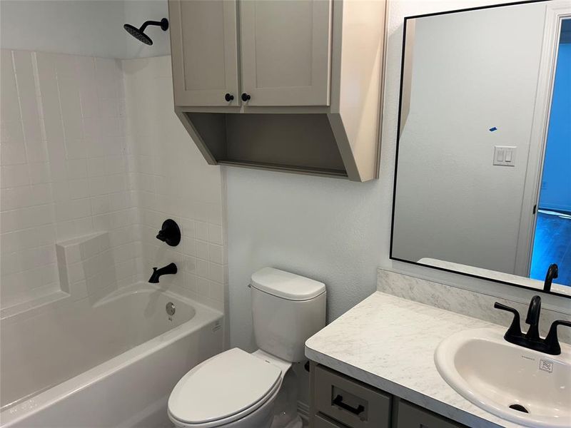 Bathroom with shower / washtub combination and vanity