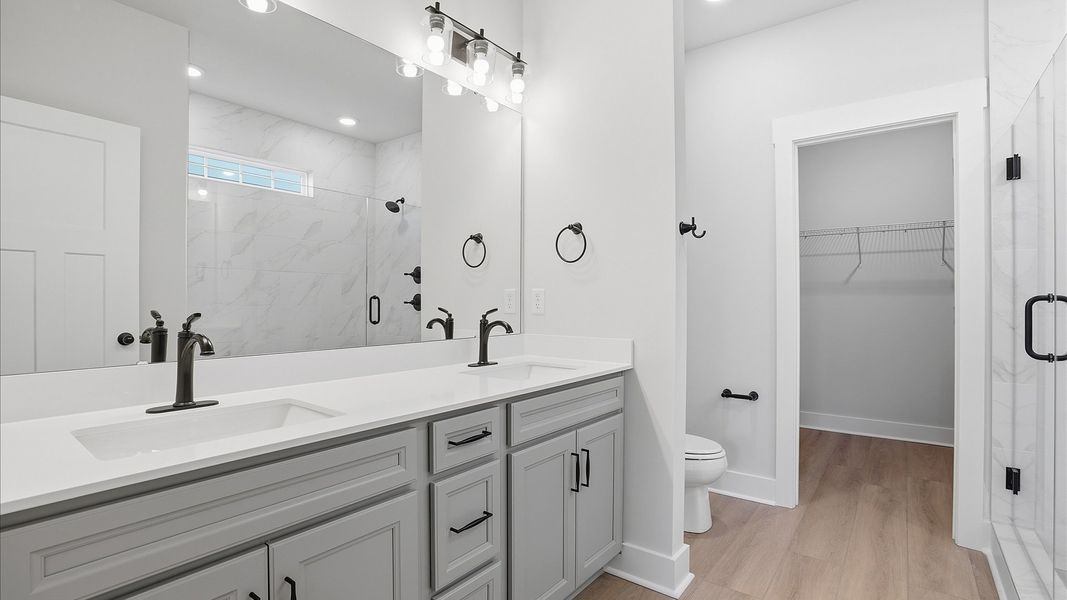 Highly functional and elegant en-suite with dual vanities, tiled walk-in shower, and refined finishes at Benjamin's Grove Highly functional and elegant en-suite with dual vanities, tiled walk-in shower, and refined finishes at Benjamin's Grove