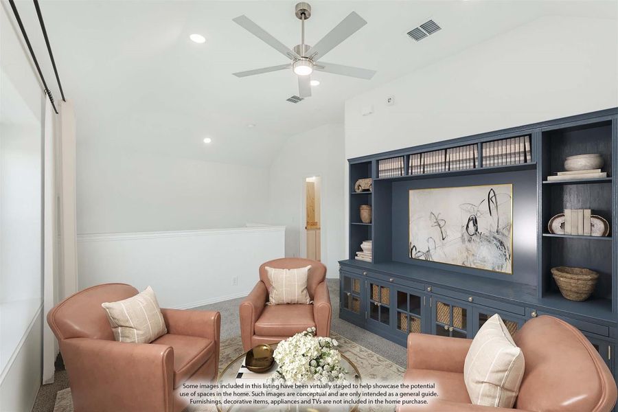 Living room with navy built-in shelving, three leather armchairs, and a ceiling fan with vaulted ceiling. Living room with navy built-in shelving, three leather armchairs, and a ceiling fan with vaulted ceiling.