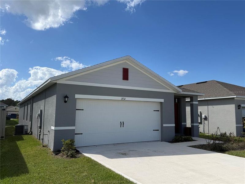 Front exterior of a new home in Villamar by Express Homes, Winter Haven, FL, highlighting curb appeal (Image 12).