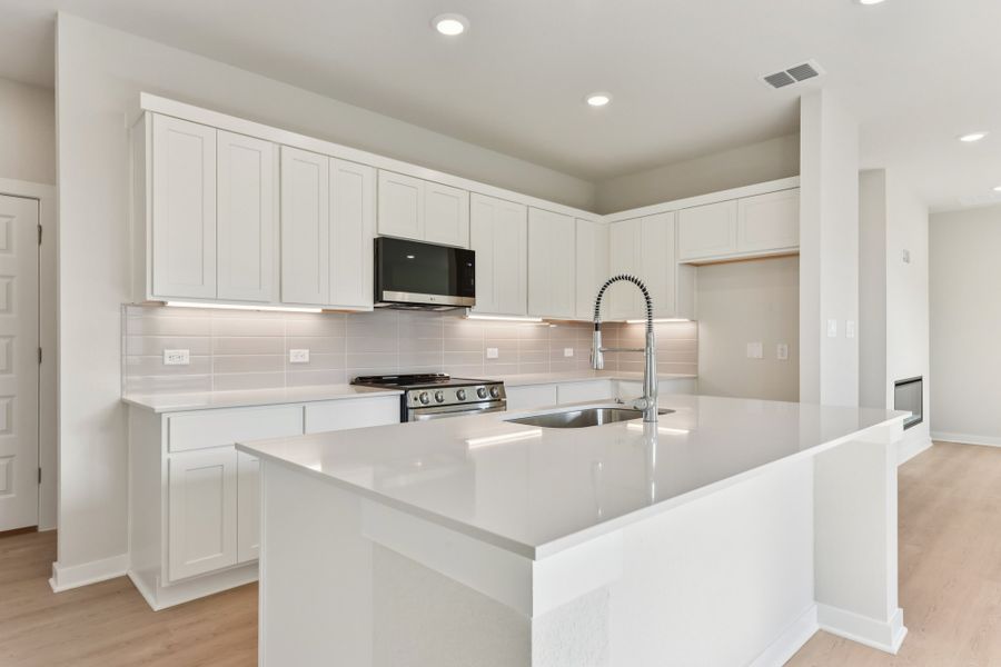 A kitchen with white cabinets. A kitchen with white cabinets.