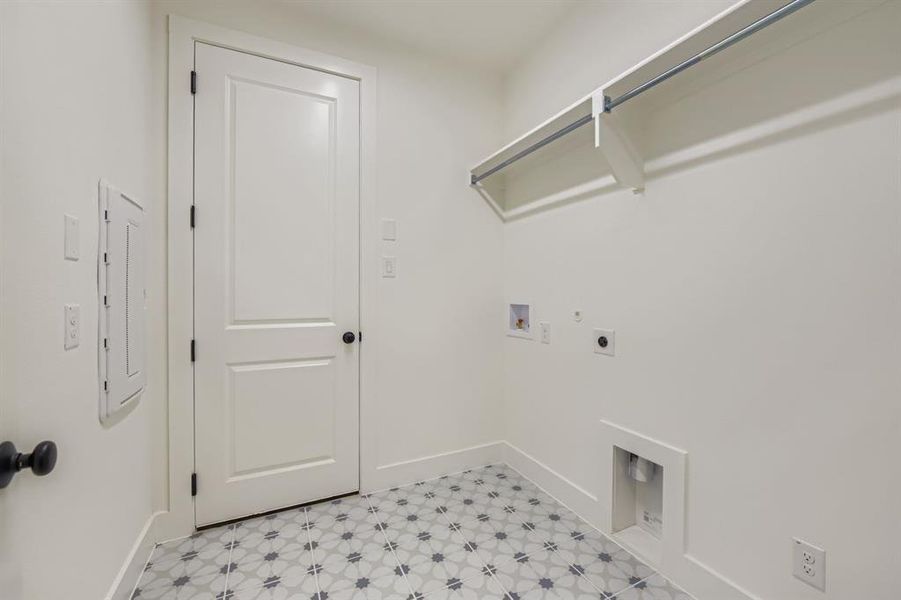 Laundry area featuring hookup for an electric dryer, hookup for a washing machine, gas dryer hookup, light floors, and electric panel Laundry area featuring hookup for an electric dryer, hookup for a washing machine, gas dryer hookup, light floors, and electric panel