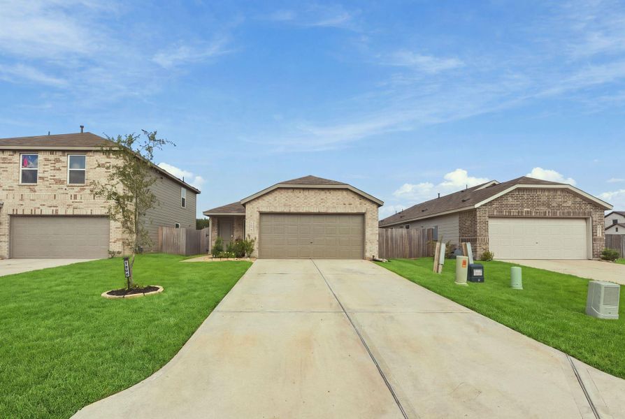 Front exterior of a new home in Caney Mills, Conroe, TX, highlighting curb appeal (Image 2).