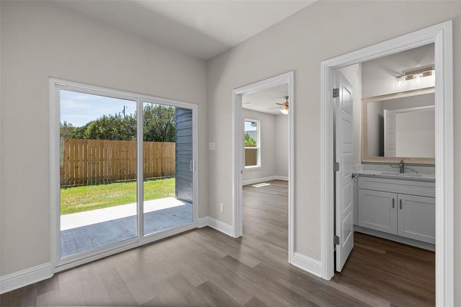 Hall featuring wood-type flooring and entry to backyard