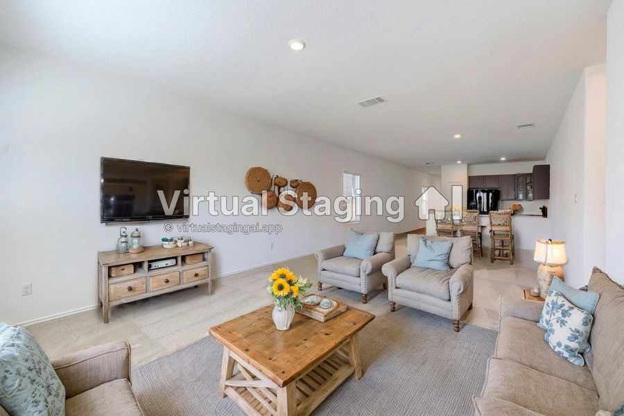 Living area featuring light colored carpet and recessed lighting