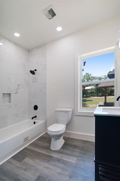 Full bathroom with wood finished floors, vanity, shower / washtub combination, and recessed lighting Full bathroom with wood finished floors, vanity, shower / washtub combination, and recessed lighting